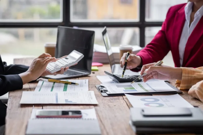 group-of-confident-business-people-point-to-graphs-2025-02-21-15-00-40-utc-1200x800